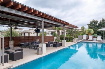 Two resort-style pools with lounging edges and cabanas